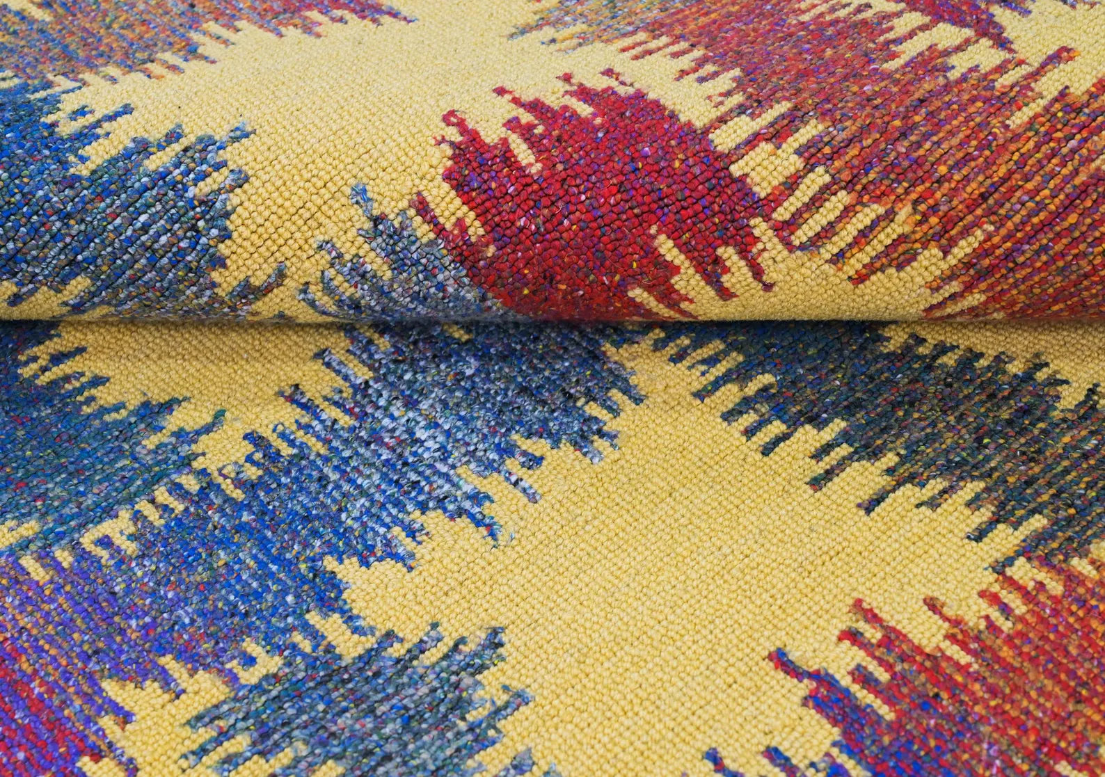 lose-up of Radiance Flow Rug showing multicolor abstract weave on a yellow base.